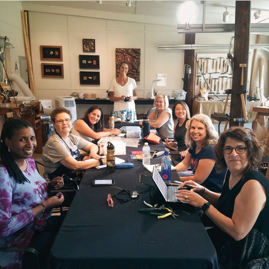 Jewelry designers gathered together on retreat.