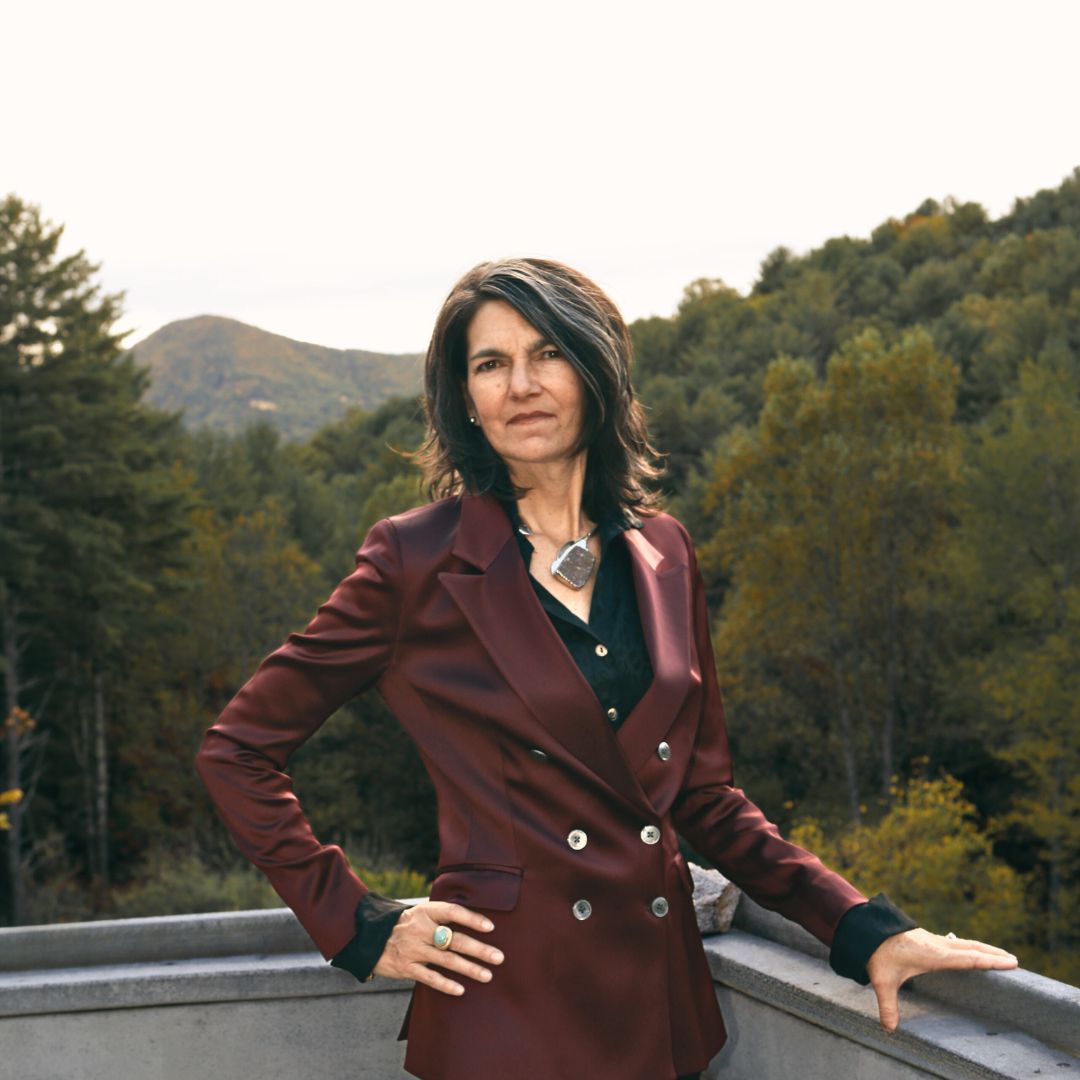 A portrait of Sarah with the mountains sprawling behind her.