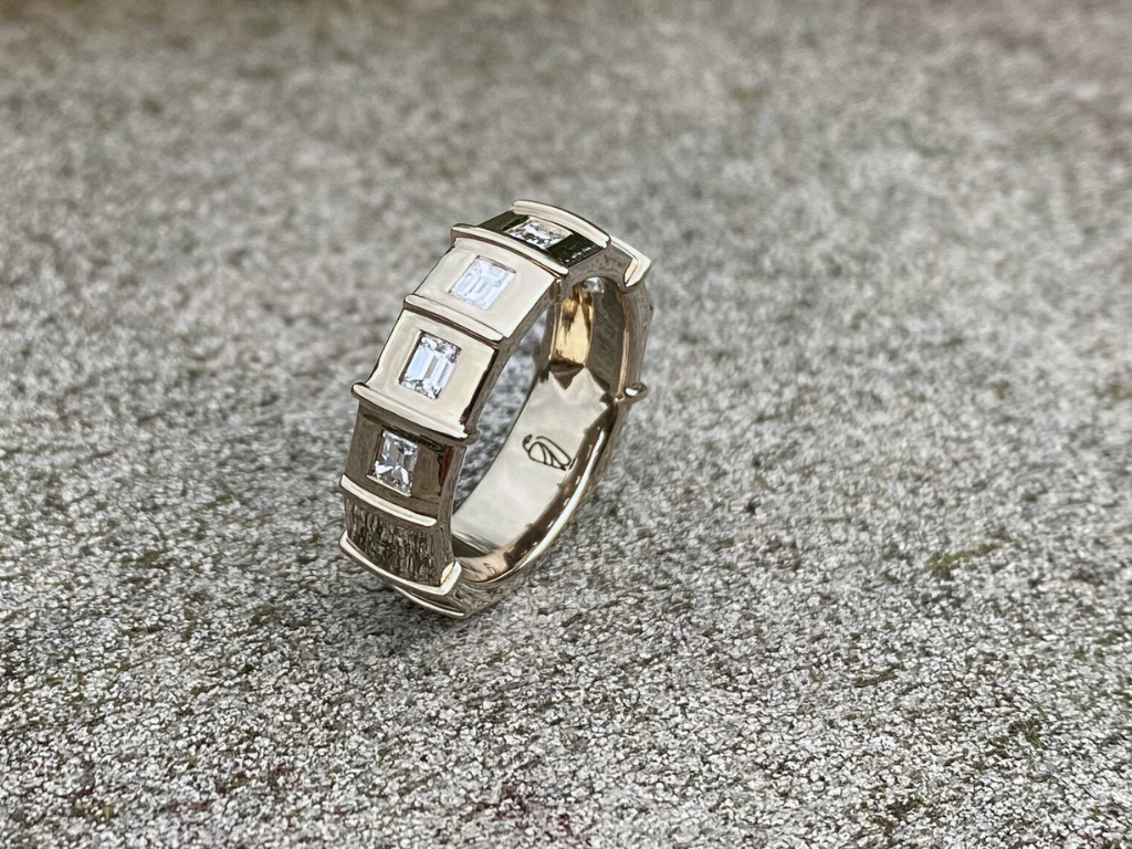 Silo Windows Ring - This elegant architectural ring features six diamond baguette diamonds symbolizing the silo's windows. The crisp standing seams in between the diamonds mimic those of the Silo’s roof line while the slight curve gives the softness needed to enhance the diamonds.