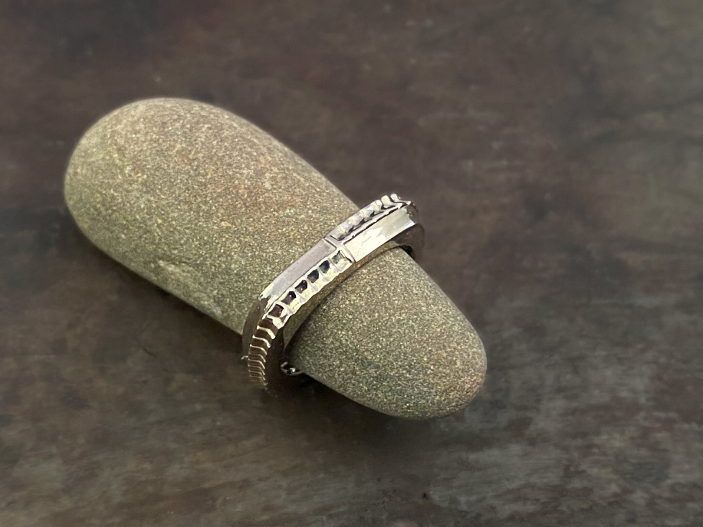 This dual sided stacking ring brings the structural standing seams and shingles of the Silo roof line to the forefront. The shingle rows switch on two sides, divided by a standing seam, so this ring on its own, can be worn two ways. Mix and match with one or two Single Shingle Rings for a striking stacking set.